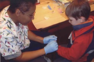 A nurse administers a lead poisoning screening to a pre-kindergarten student through the New Britain Health Department.