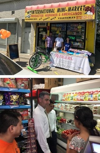 People in a grocery store and a table for the Healthy Corner Store Initiative