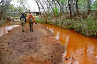 Two people walking on Superfund site