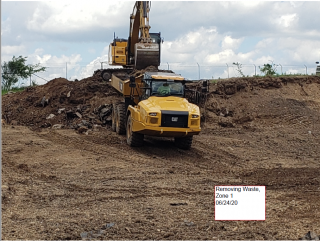 Heavy equipment removing waste from Zone 1