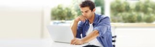 Photo of man looking at a computer screen.