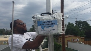 A Denver student checks an air quality monitoring station