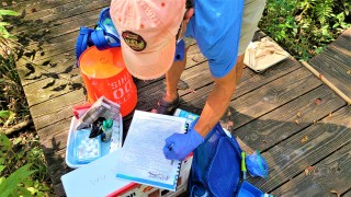 citizen scientist conducting water monitoring