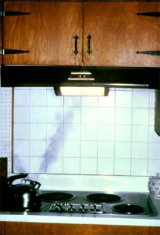 Example of an exhaust hood and fan over a stovetop in a kitchen.