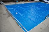 Pool cover in use over a pool.