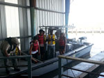 Student on boat getting ready to take water samples