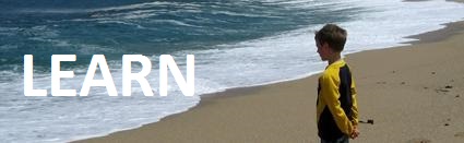 Boy standing by body of water