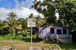 Acquired House with Sign reading El Cano es Tuyo! Protegelo!