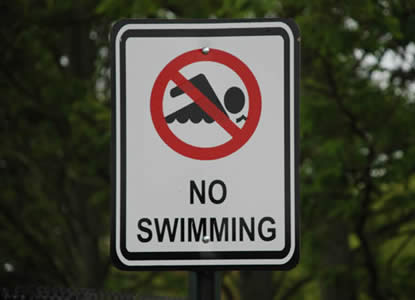 No Swimming Sign: Bacteria in polluted runoff cause the closure of beaches and shellfish beds.