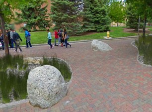 Artistic rendering of bioretention, permeable pavers, and decorative boulders on University of New Mexico campus.