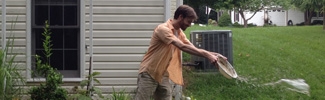 Man pouring out water that could be used as mosquito breeding habitat