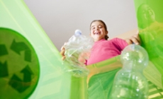 photo of girl throwing bottle in recycle bin photo of girl throwing bottle in recycle bin
