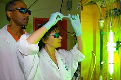 Ms. Amy Zhao and Dr. Endalkachew Sahle-demessie withdraw sample material to test effects of Ultra Violet light and zero valance iron on Perchlorate concentration in water.