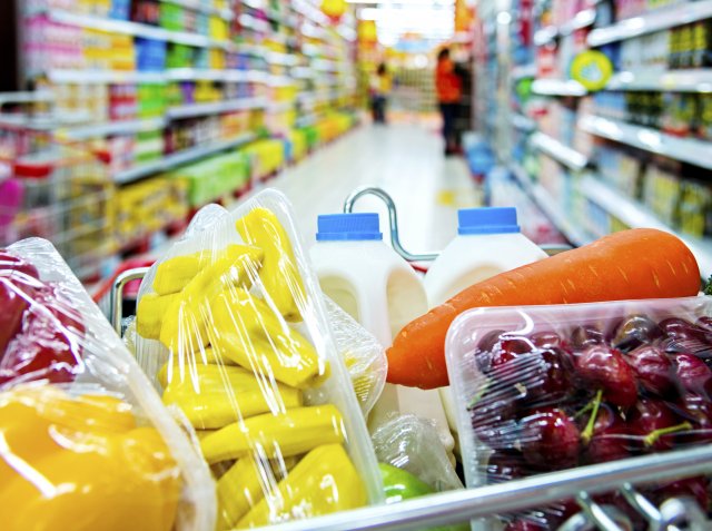 shopping cart with colorful fruits and vegetables in it