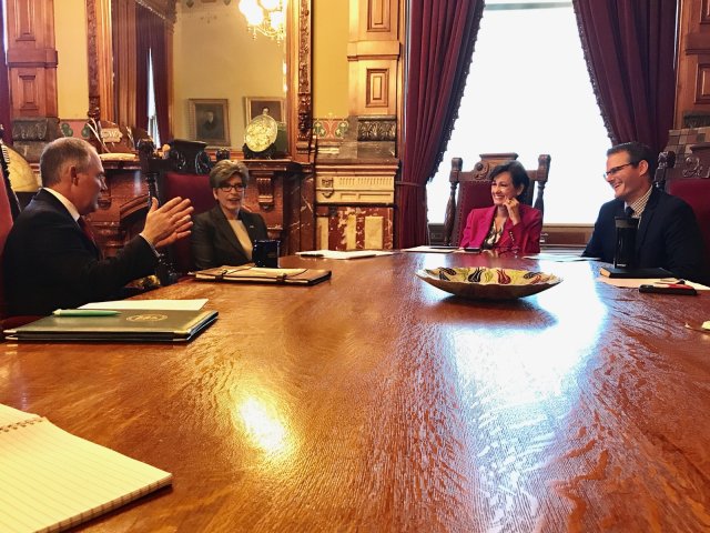 EPA Administrator Pruitt sits at a large wood table in an ornate office gesturing with he discusses WOTUS and other Agency priorities with (left to right) U.S. Senator Joni Ernst, Iowa Governor Kim Reynolds, and Iowa Lt. Governor Adam Gregg.