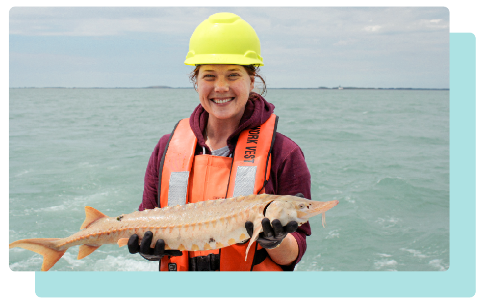 EPA employee holding a large pink fish.