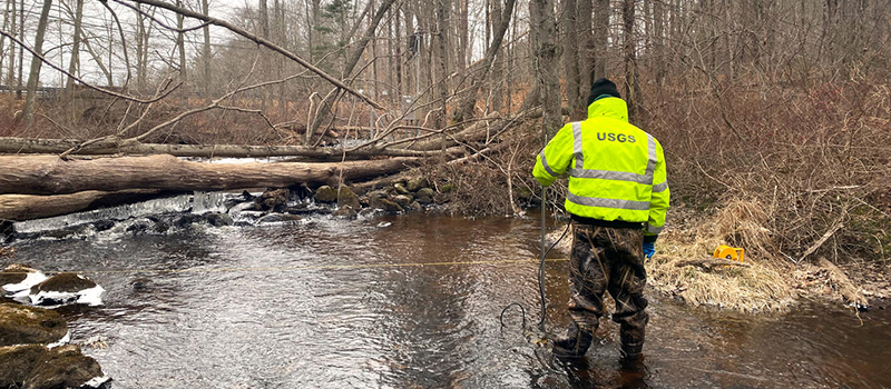 Hydrologic Technician measuring discharge for nutrient load calculations at Wilbur Hollow Brook near Clayville, RI (Photo Credit: USGS)