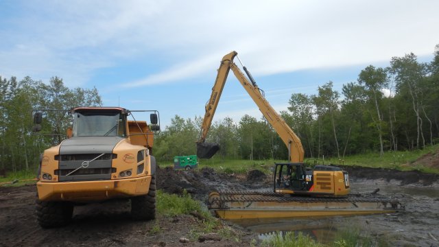 Impacted sediment is removed from the Unnamed Pond and transported to the sediment processing area.