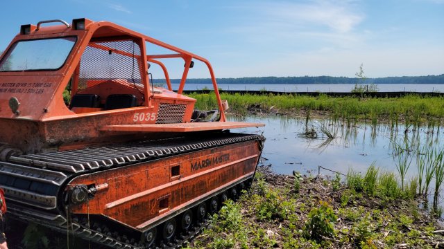 An amphibious construction vehicle is used to survey Wire Mill Pond before dredging activities begin.