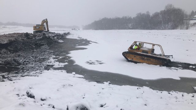 The contractor uses an amphibious vehicle to perform a topographic survey in the Shallow Sheltered Bay.