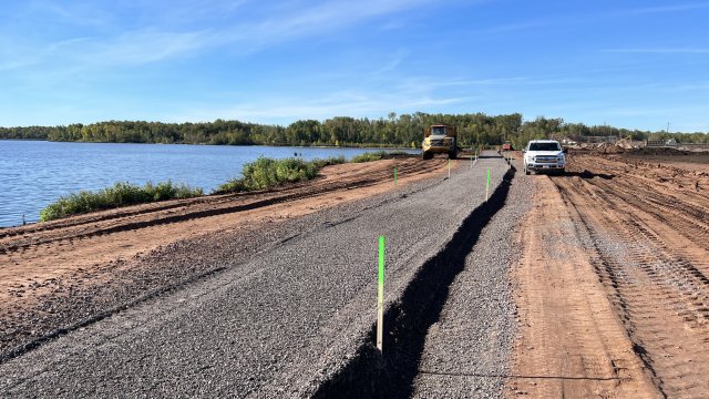 Gravel is placed along the Delta Upland Cap to create part of the pedestrian walking trail .