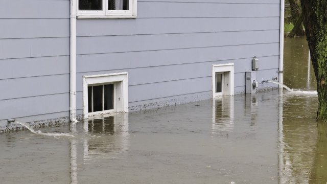 impact of air travel on global warming Side of house in floodwater