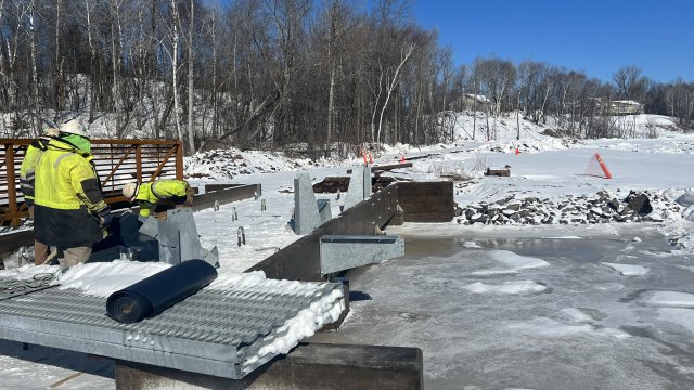 Construction work installing walkway and handrails on cold winter day