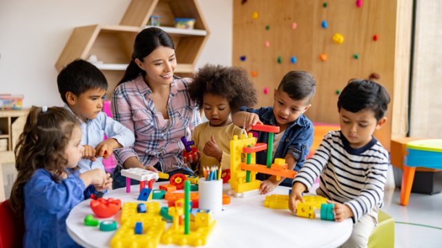 Group of children and teacher at child care. 