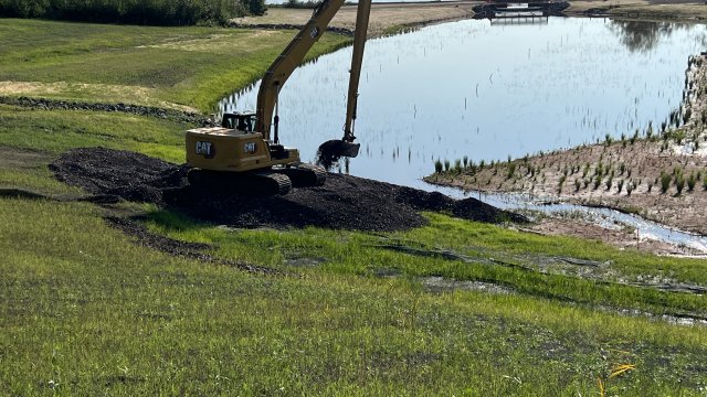 Large machinery slope stabilization work near Wire Mill Pond