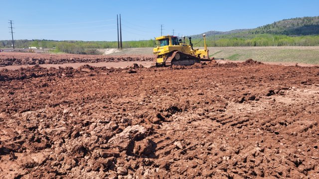 Clay is placed on the OU-J Confined Disposal Facility.