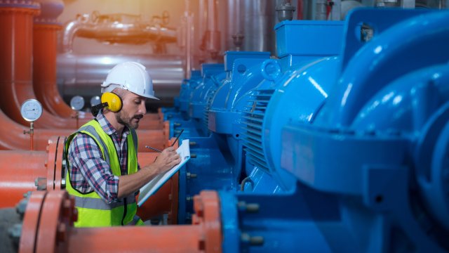 Mechanical engineer Checking of centrifugal pump in pump room. worker working in plant room.