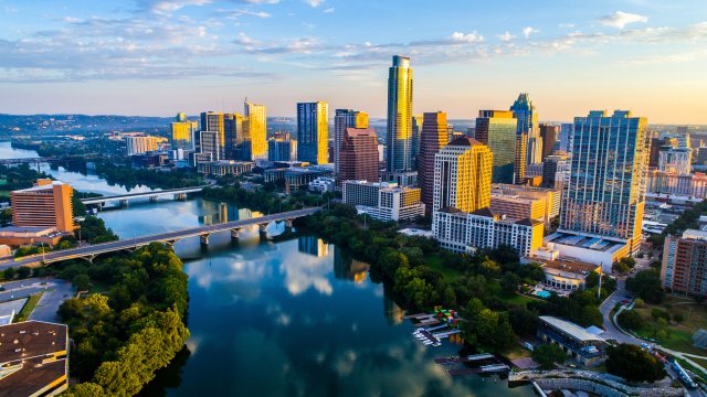 Skyline cityscape over lake with reflection.