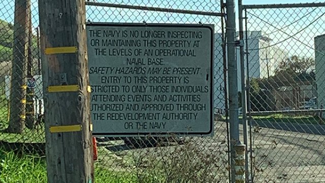 A chain linked fence with a caution sign noting that the facility within the grounds is no longer being inspected.