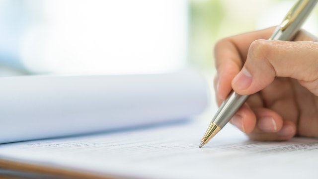 Person writing on paper