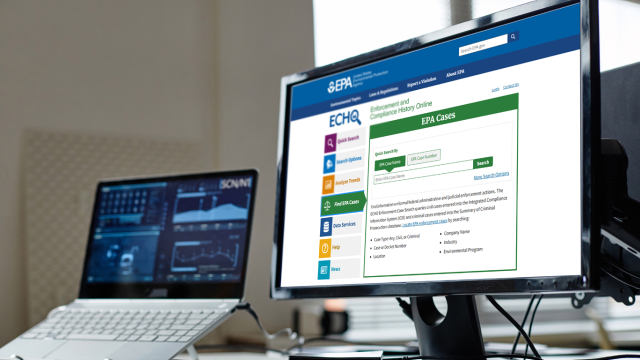 large and small monitors on a desktop. one with graphs and one with a search screen