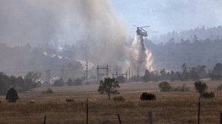 Firefighting helicopter putting out a fire