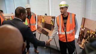 Administrator Regan shaking hands with a community member
