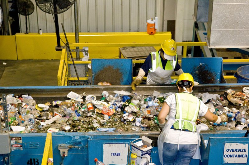 Picture of a man sorting a large container of recycling