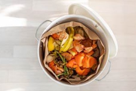 Overhead photo of compost in a white bucket. 