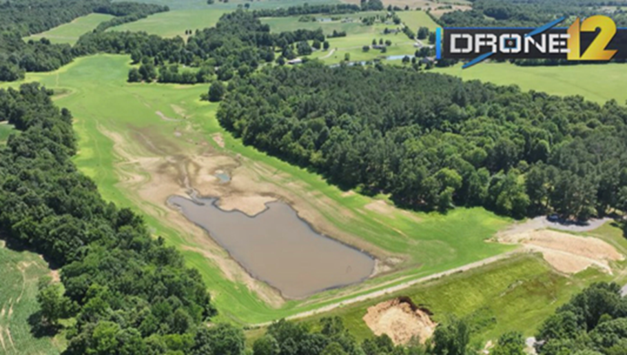 An aerial drone shot of the Marion Reservoir, showing levee failure in the bottom of the screen and a reduced water supply.