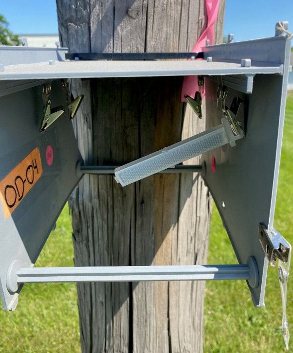 rectangular sample media on a wooden post.