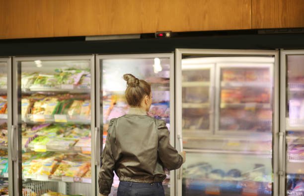 Women choosing frozen food from supermarket