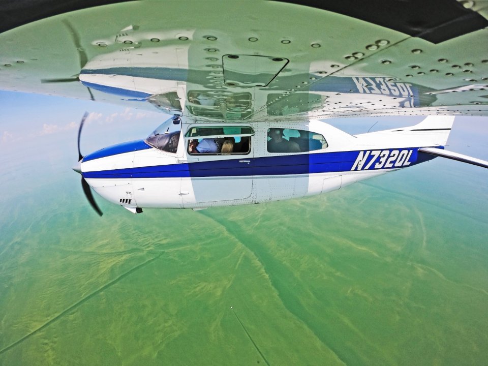 Scientists aboard a small aircraft obtaining hyperspectral imagery of a Lake Erie algal bloom. Credit: NOAA