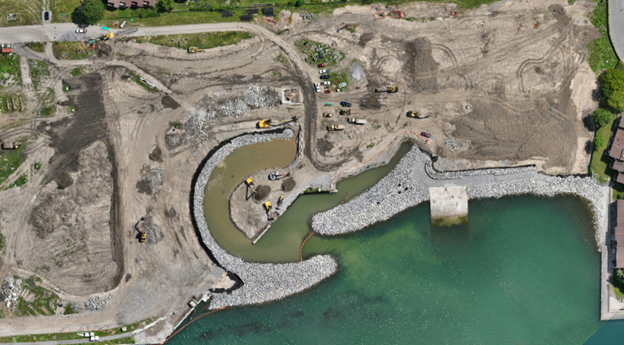 Aerial of the construction area with equipment and the seawall.