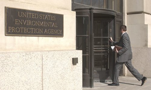 man in a suit walking into the revolving door at the United States Environmental Protection Agency building in Washington, DC