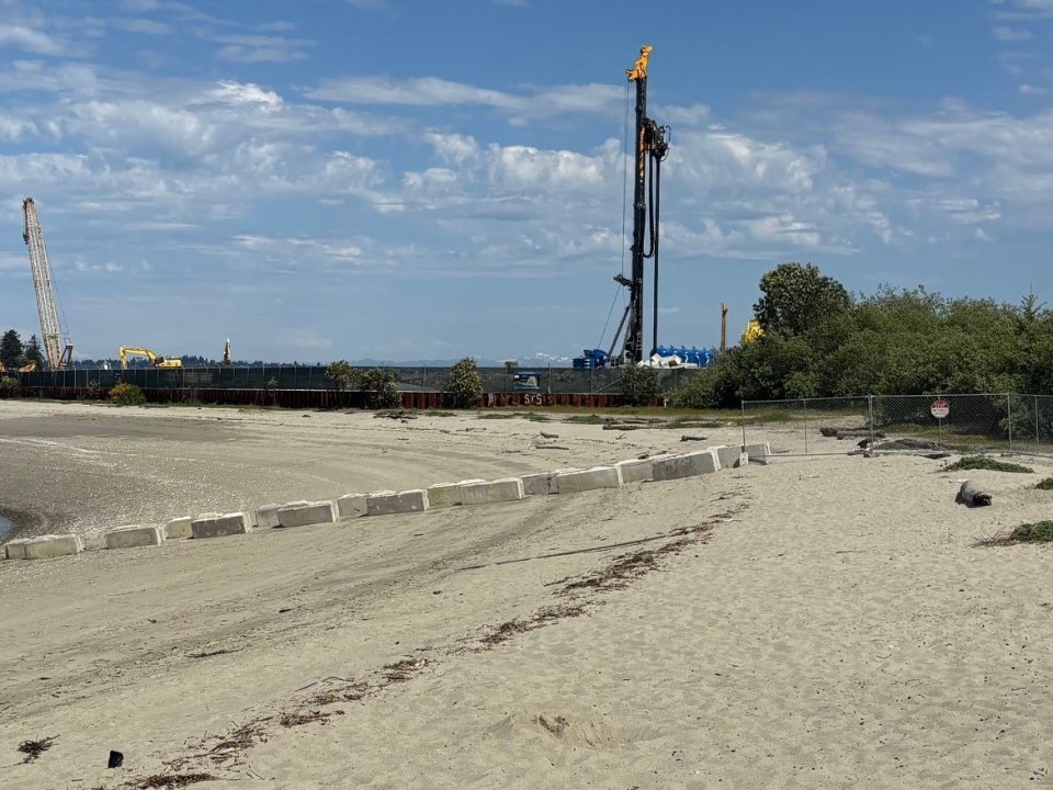 Beach area with concrete barriers and fence blocking access.