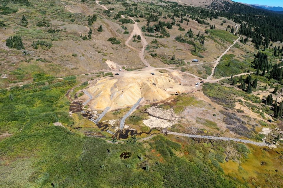 An aerial view of a mine in a mountainous region.