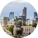 round graphic of a city skyline during the daytime