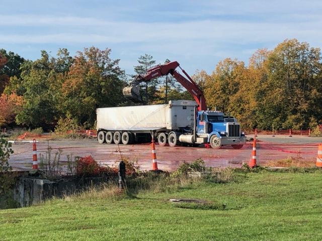 AFTER: A last load of asbestos containing material is removed from the site.