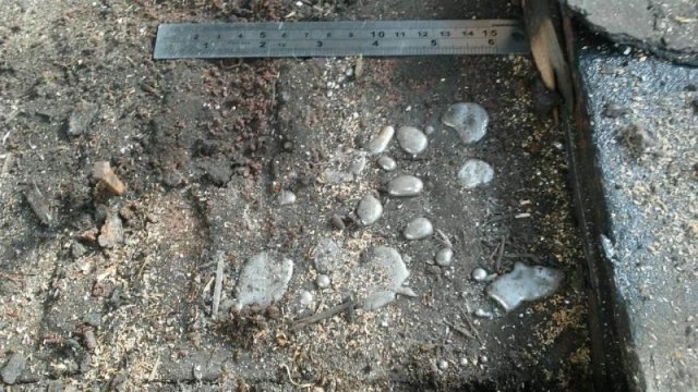 A picture containing ground, concrete, cement, stone and mercury contamination.